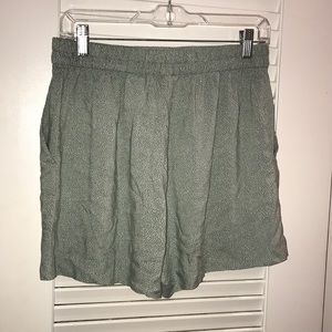 Green high waisted shorts with white specks
